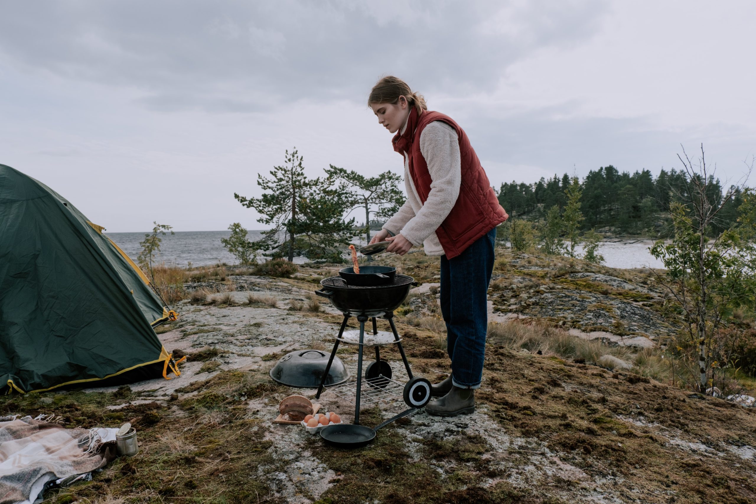 Grillen im Norwegenurlaub Frau grillt in der Natur