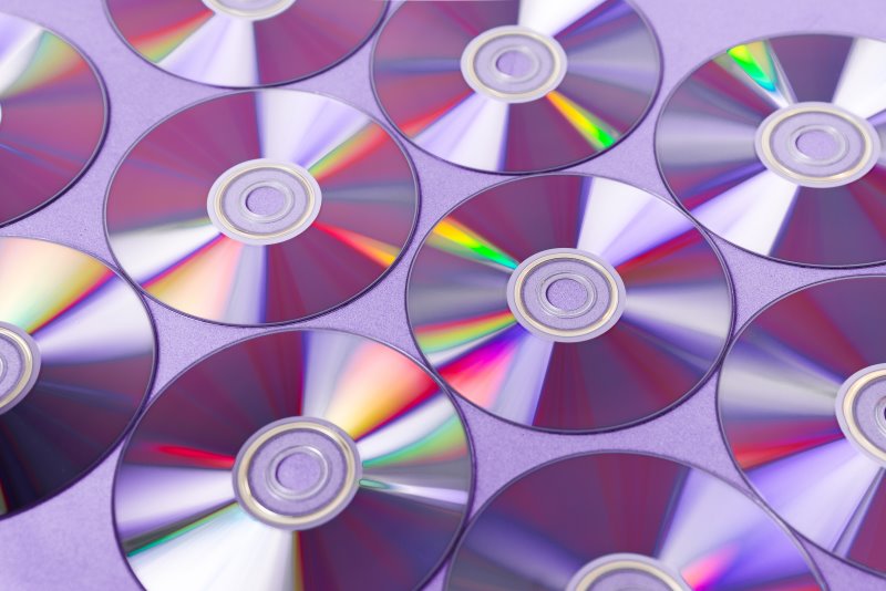 Verschiedene CDs und DVDs liegen auf einer ebenen Fläche
