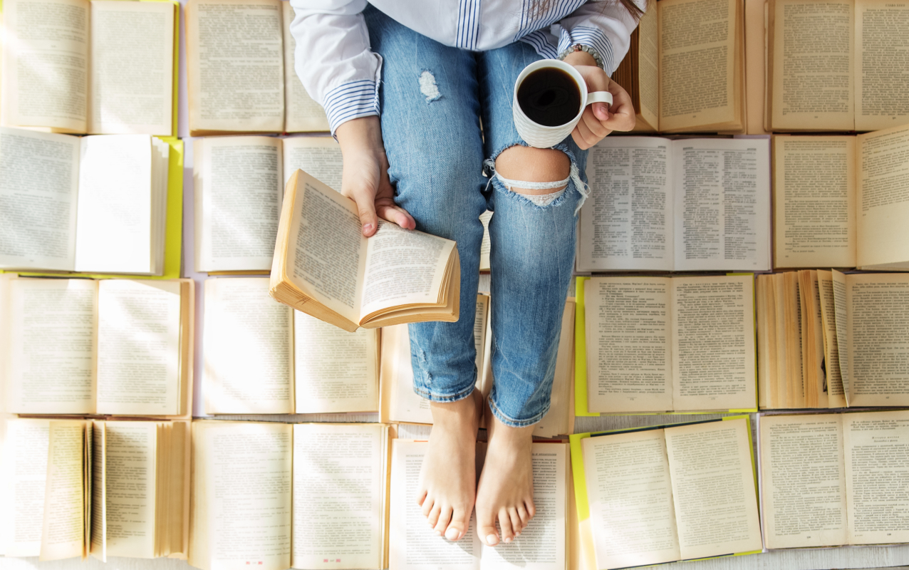 a-young-woman-reads-a-book-and-drinks-coffee